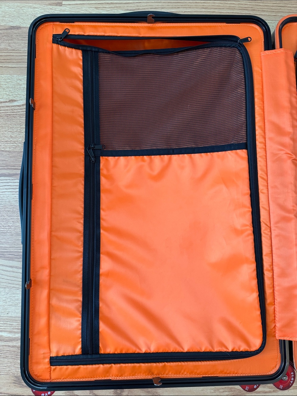 Floyd Brown Hardshell Suitcase with Bright Orange Interior and Red Wheels - Picture 15 of 17